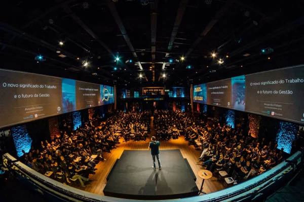 Corporate event with large digital displays and many guests