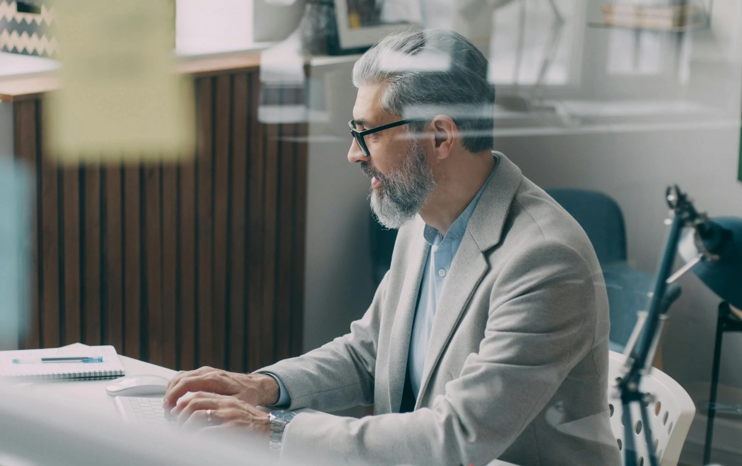 Man in an office using a mobile telephone