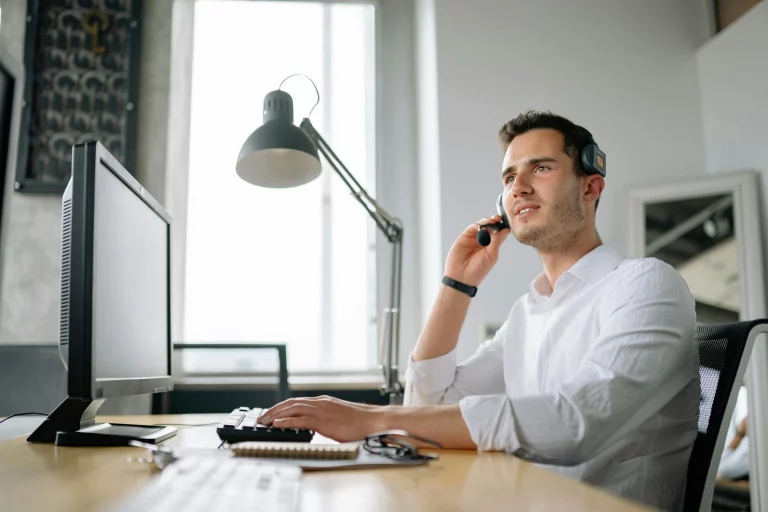 Man with headset sitting at a desk