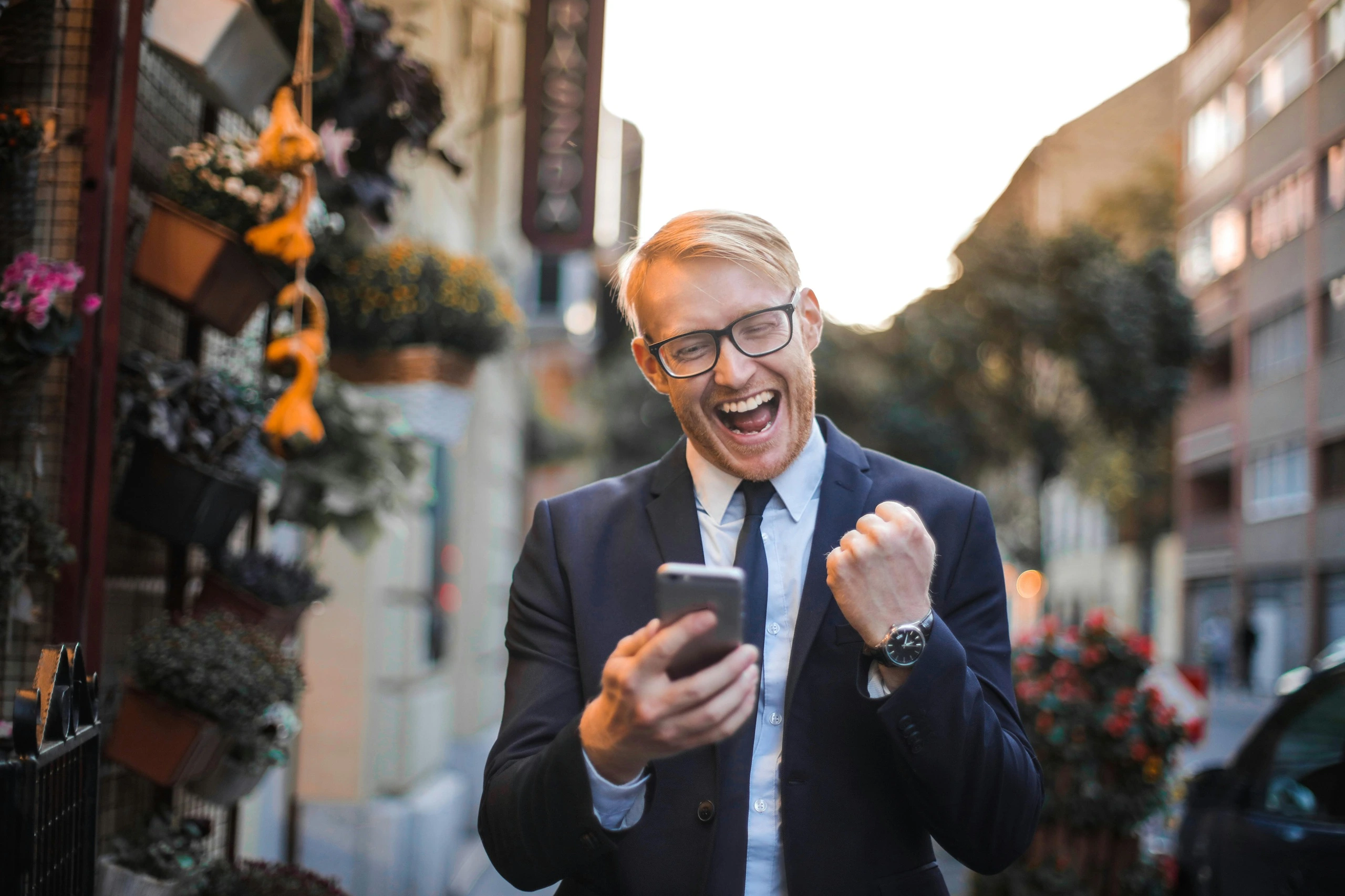 Man with big smile looking at his mobile phone